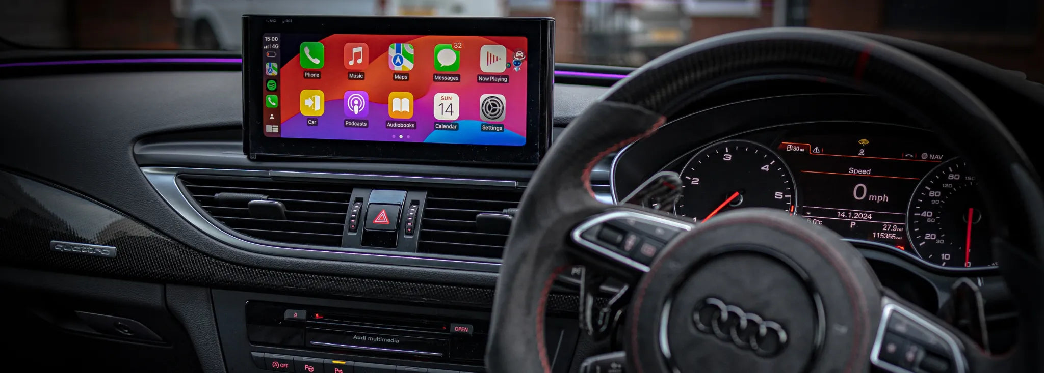 Audi dashboard interior with Apple CarPlay display and steering wheel controls